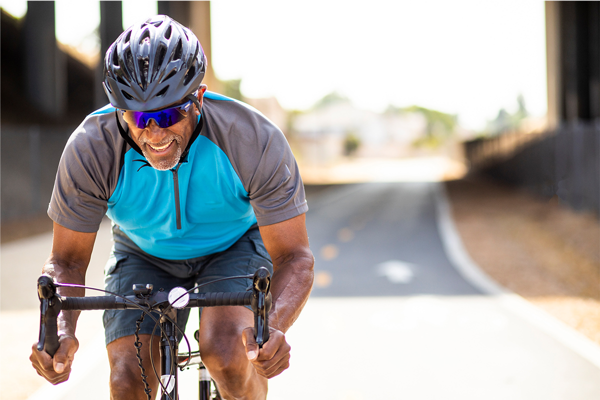 senior man cycling in the road