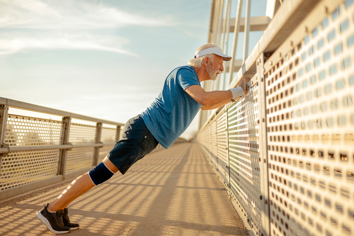 senior man doing wall push ups