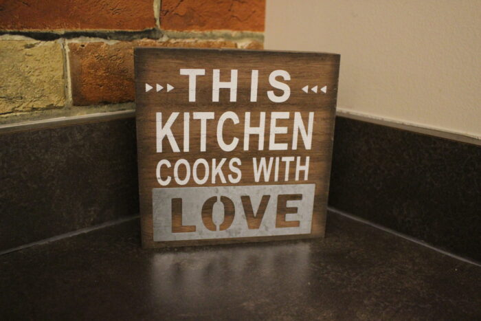 this kitchen cooks with love sign