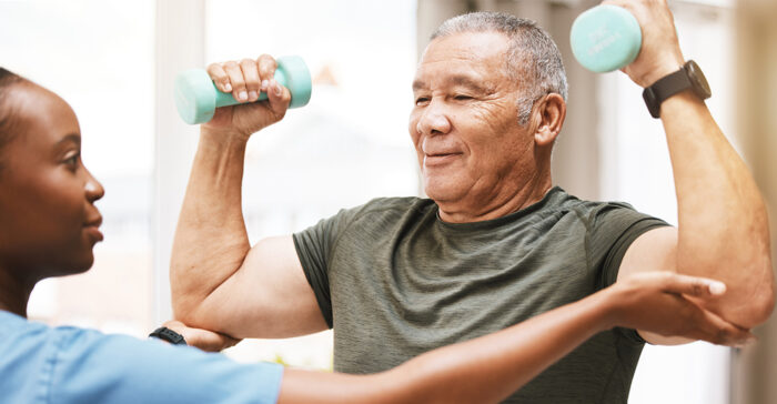 senior and physical therapist exercising