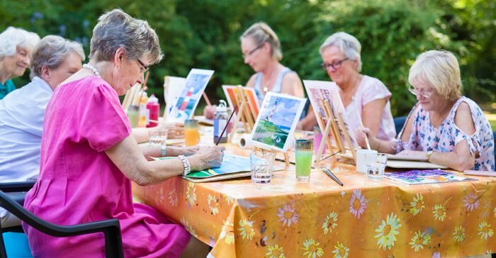 Seniors painting outside