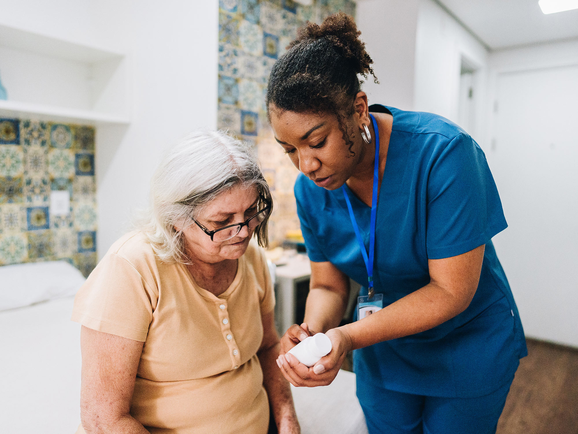 Senior and her caregiver looking at a prescription together