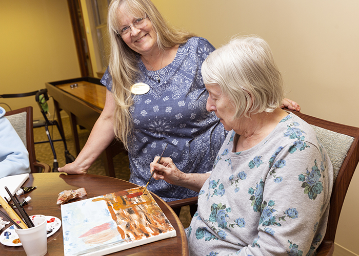 StoryPoint Senior Woman Painting with Caregiver