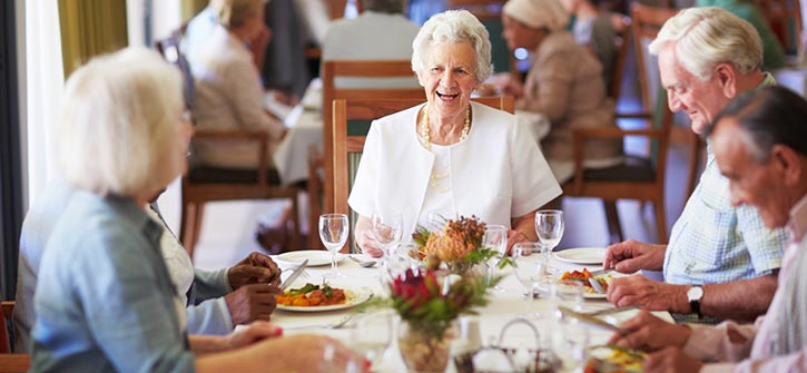 seniors having dinner together in a community dining room