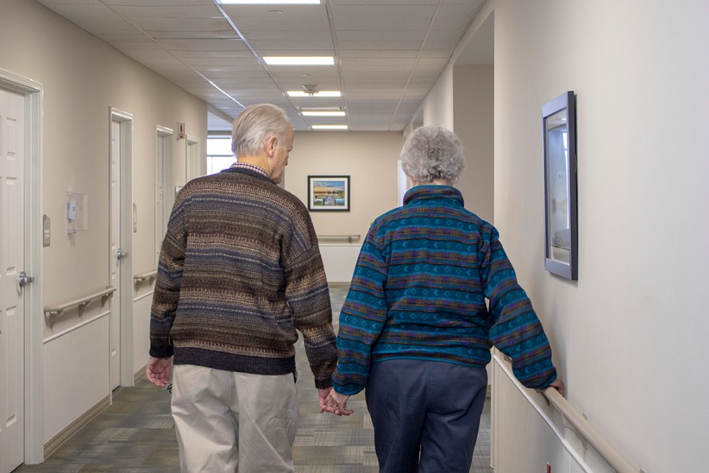 two StoryPoint residents holding hands and touring the community