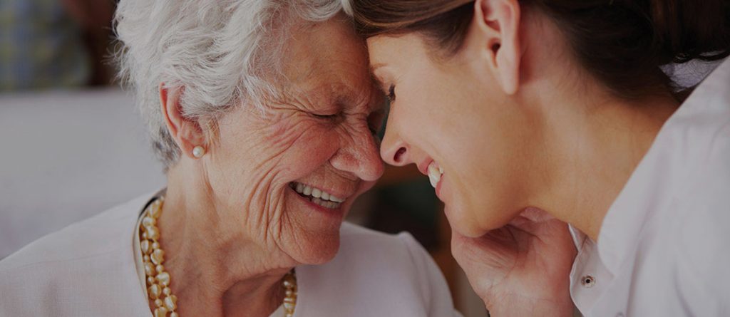 mother and daughter smiling and embracing each other