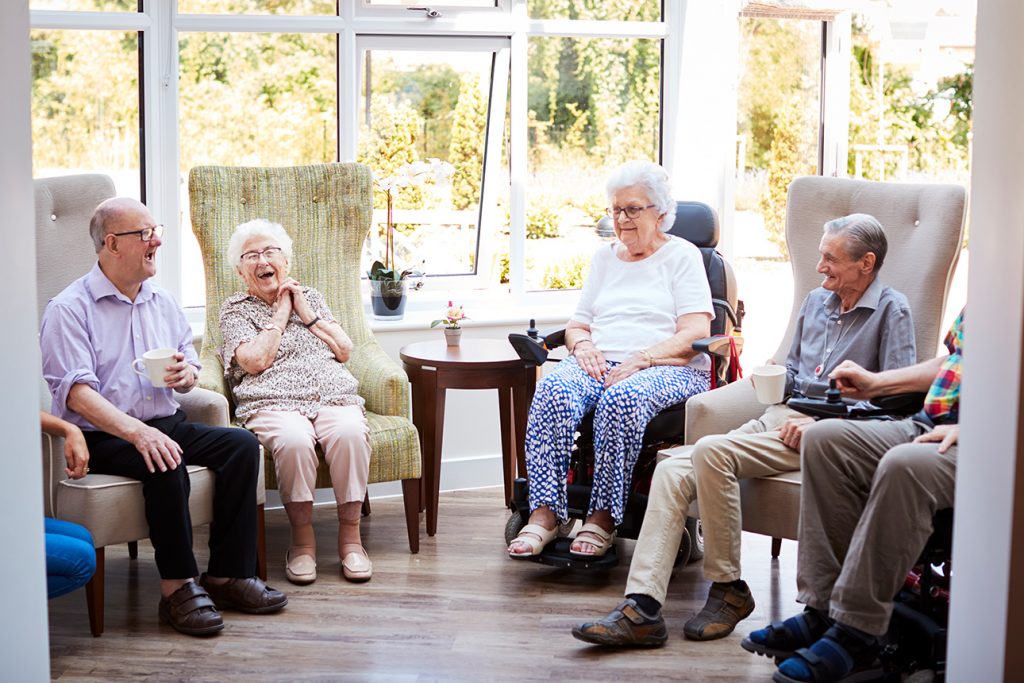 seniors laughing and talking together in a senior living community