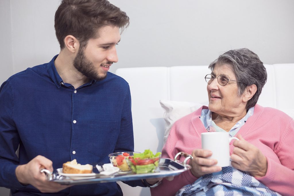 Mother and son bonding and talking over coffee and snacks