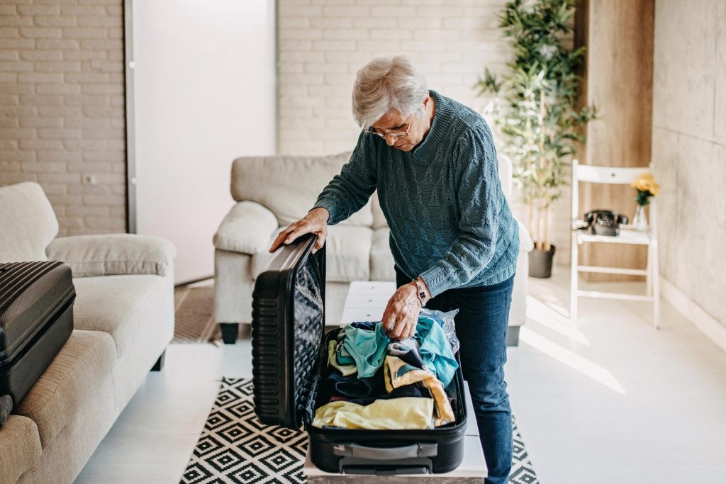 senior women packing the essentials as she gets ready to travel