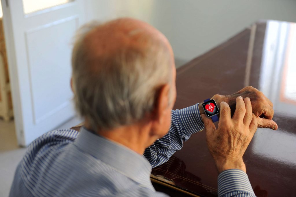 senior checking a heart rate monitor on a smart watch