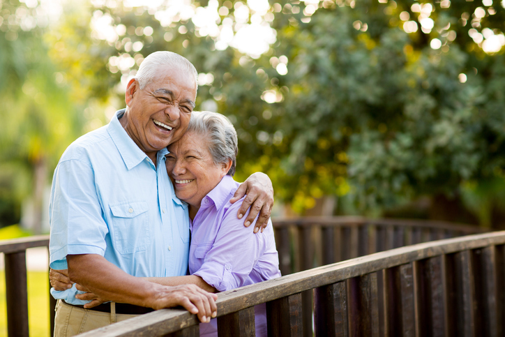 A senior couple laughing together on bridge