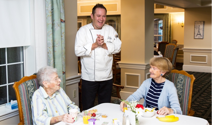 StoryPoint chef with residents while they are eating