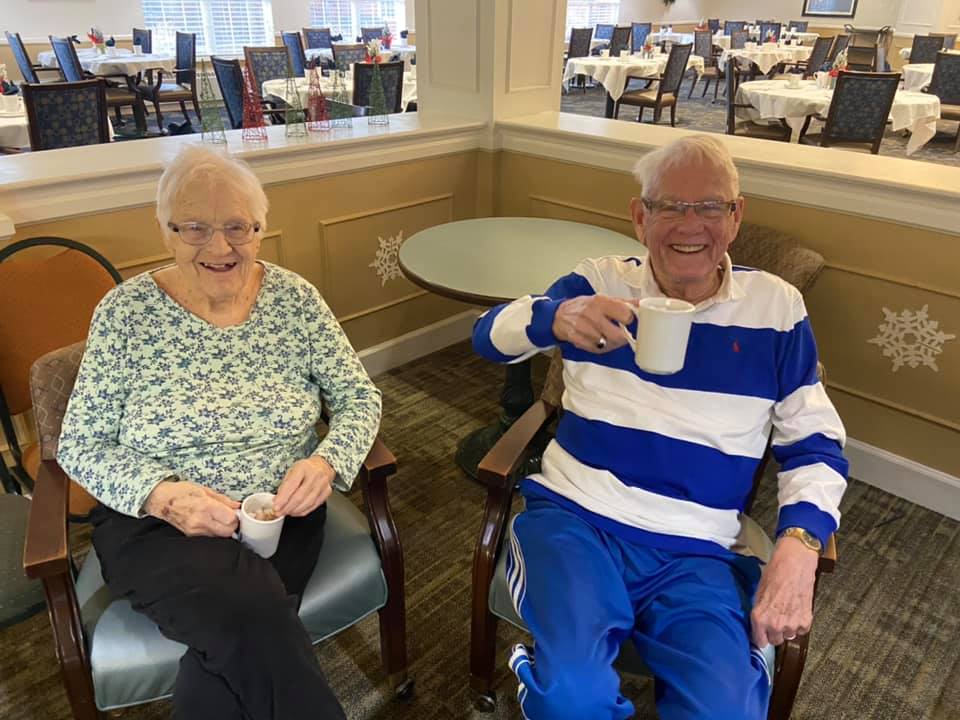 two residents enjoying coffee together in dining room