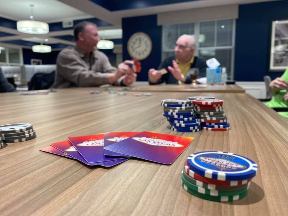 residents playing poker and other card games together 