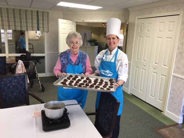 StoryPoint resident and chef showing off their cookies