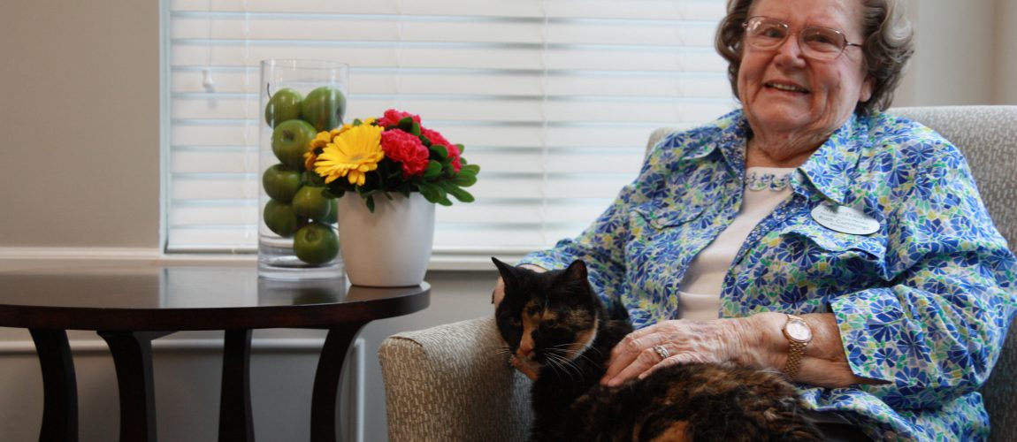 senior living resident with her cat 