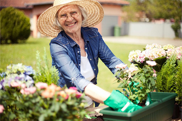 senior woman in hat gardening