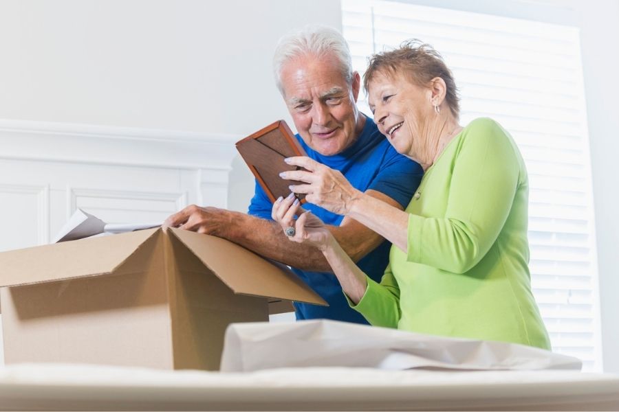 Senior couple packing to move