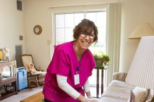 maintenance woman smiling while cleaning