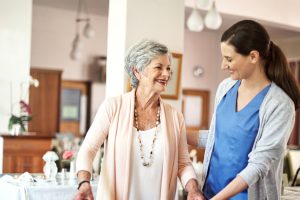 senior woman with young woman caregiver
