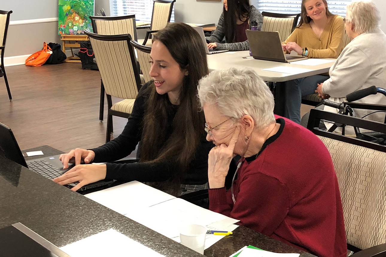 smiling caregiver going over important documents with a resident