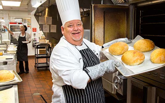 senior living community chef baking bread