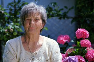 senior woman with pink flowers