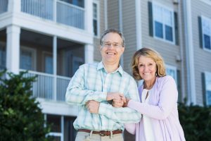 Mature couple in front of apartment building