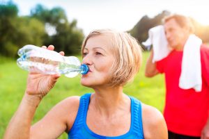 woman drinking water outside