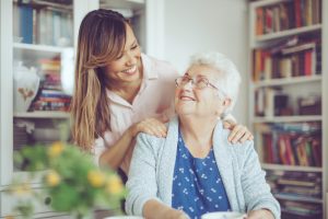 caregiver and senior woman at home