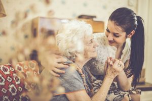 caregiver comforting senior woman