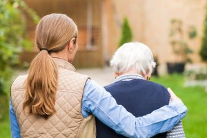 caregiver walking with a woman in the park