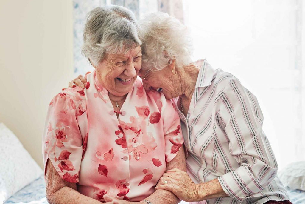 senior woman laughing and hugging