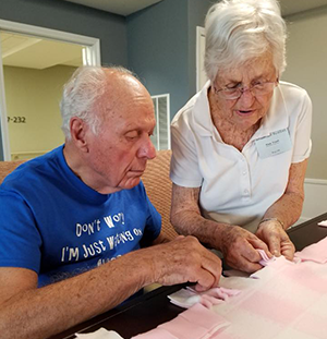 senior living residents making blankets for project Linus