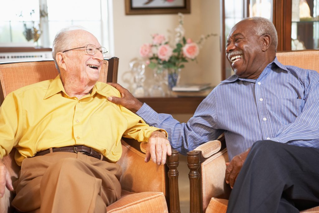 senior living residents talking in the community lobby