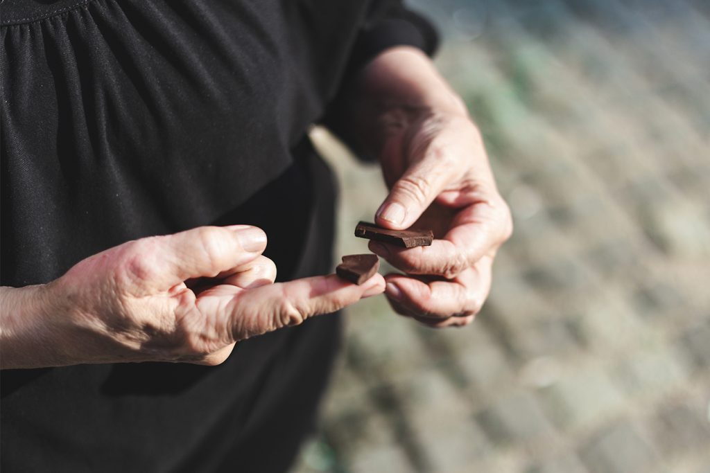 elderly women enjoying dark chocolate to help boost her immune system