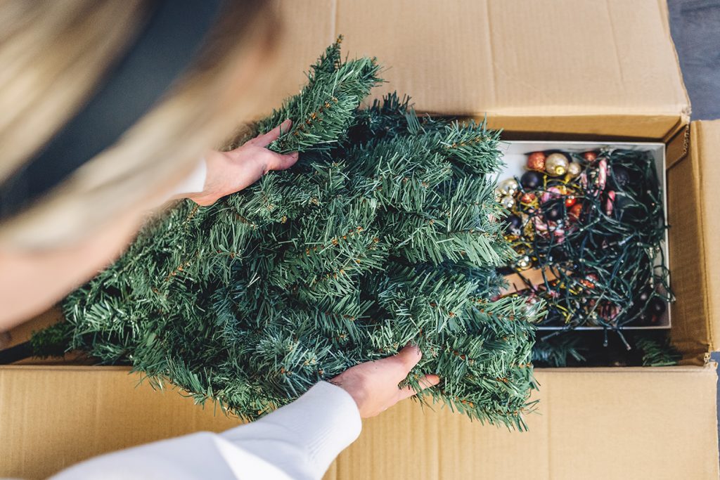 senior women packing away seasonal decoration and sending them to storage