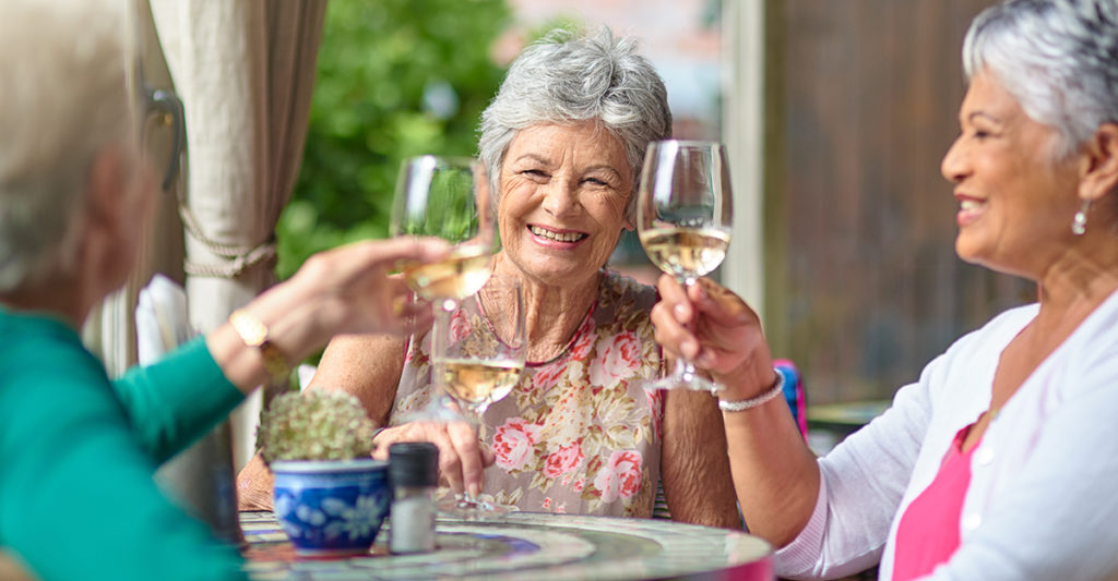 senior living residents having wine together