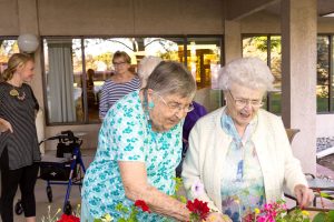 senior living residents admiring flowers
