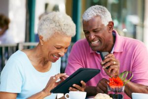 Senior couple at a cafe working on a tablet