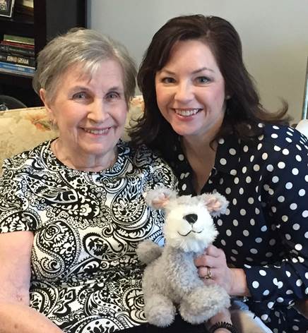 mother and daughter holding a stuffed animal 