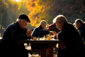 seniors playing chess at the park