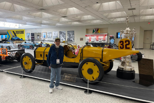 senior man in front of classic car