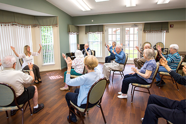 group of seniors exercising memory care residents
