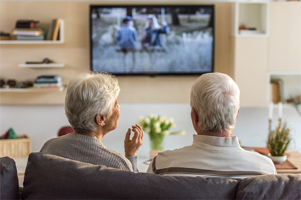 senior couple watching tv resident