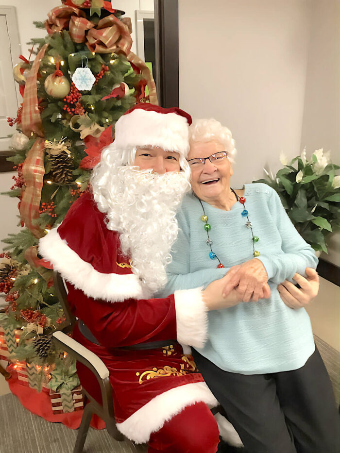 senior living resident with Santa