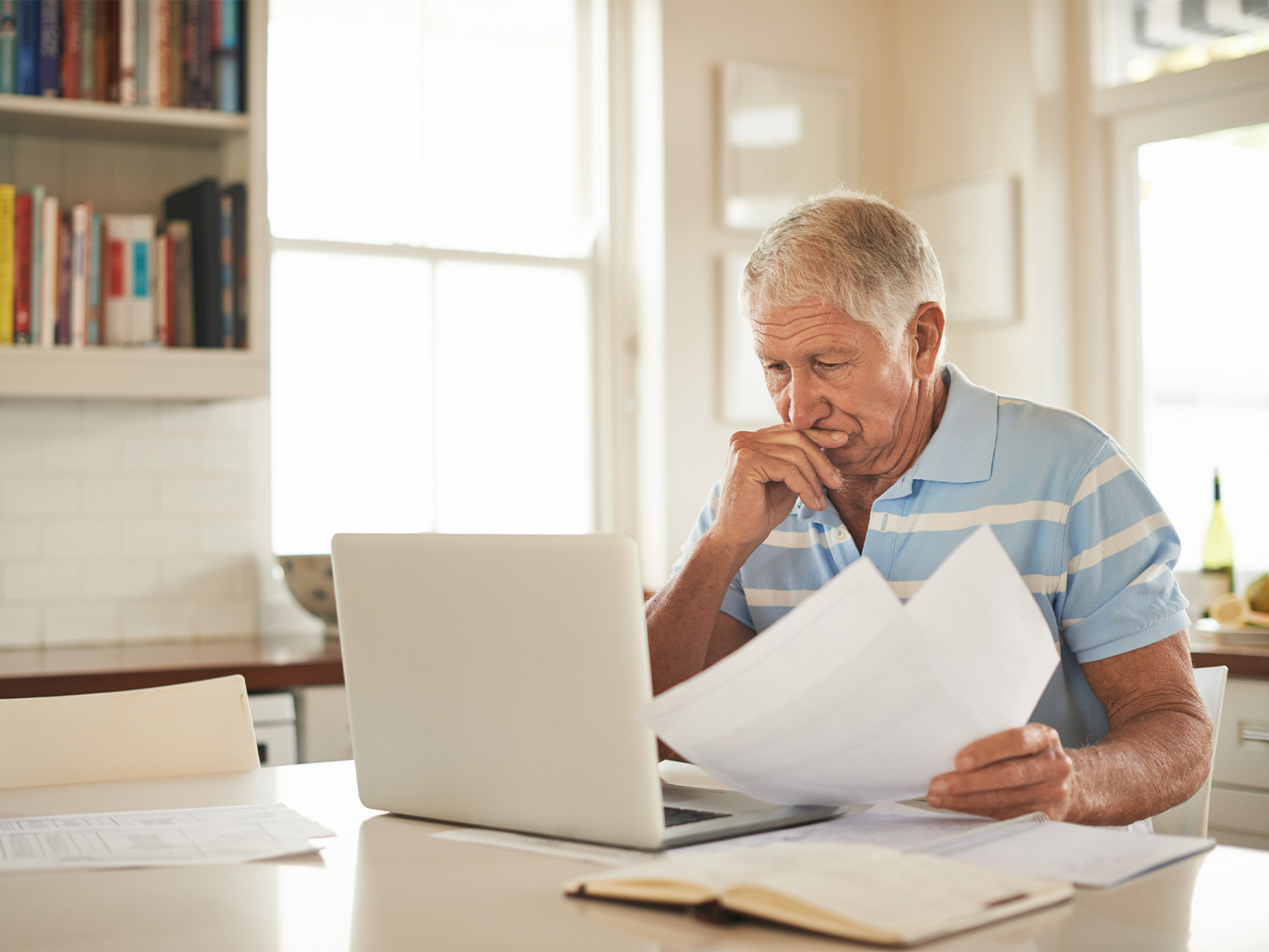 senior calculating the cost of assisted living on a computer