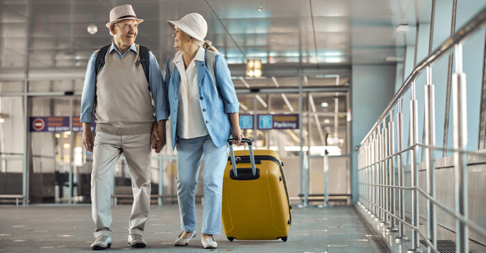 senior couple walking in the airport