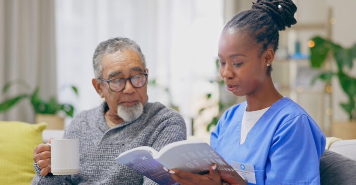 nurse reading a document to a senior
