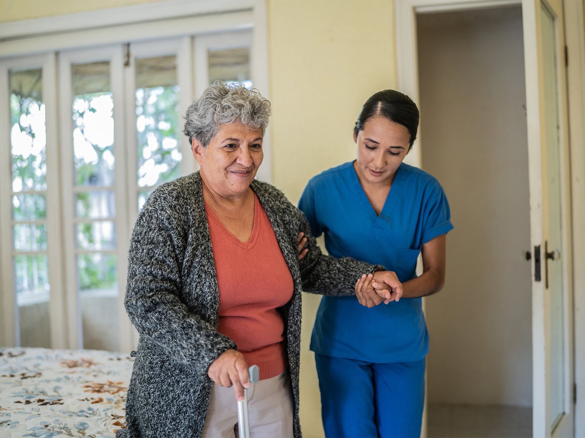 nurse helping elderly woman